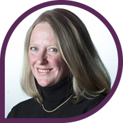 Woman with blonde hair wearing black turtleneck