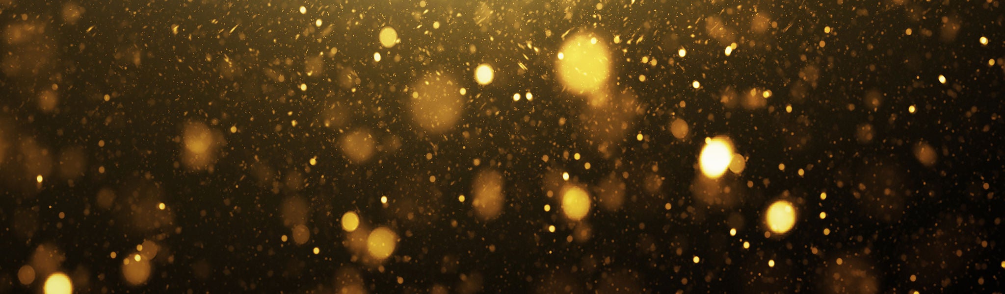 Golden glitter particles in soft focus