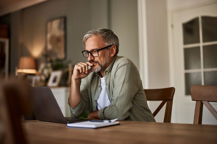 Man working on laptop in home office