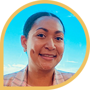 Woman in plaid blazer under blue sky