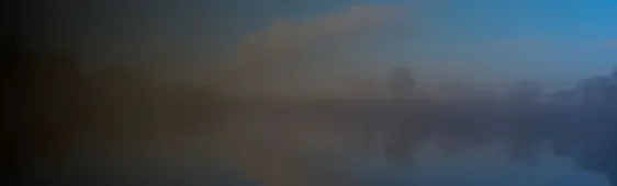 Serene lake at sunrise with mist