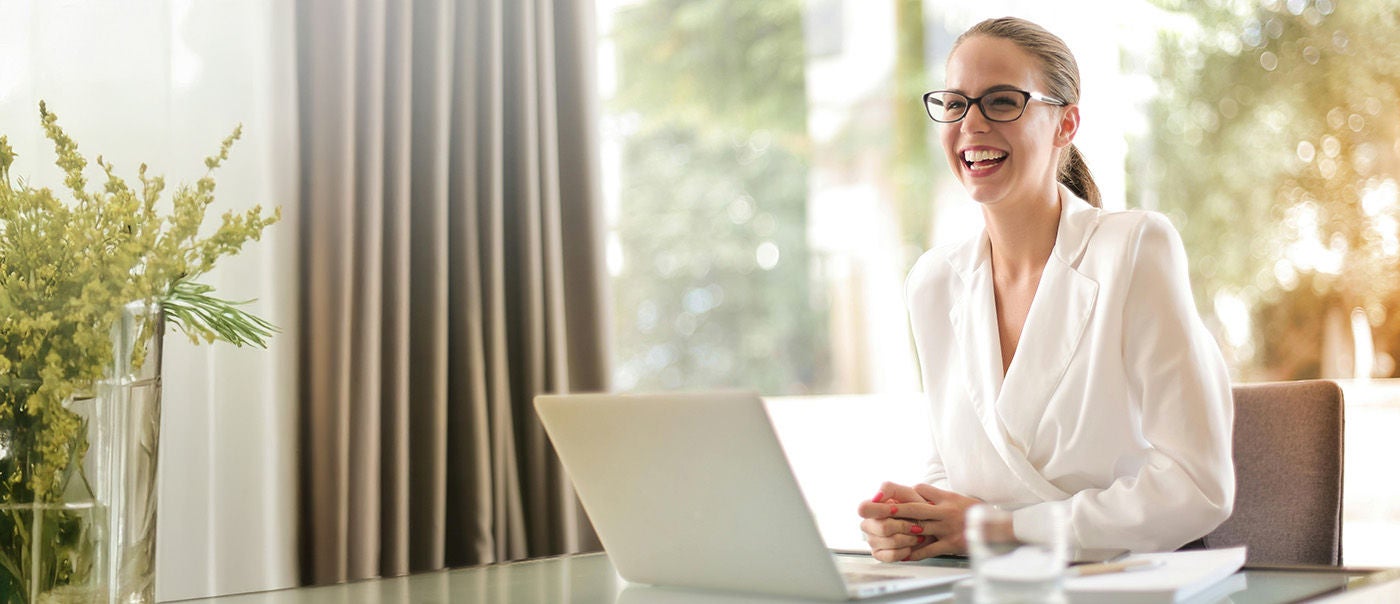 Professional woman working on laptop indoors